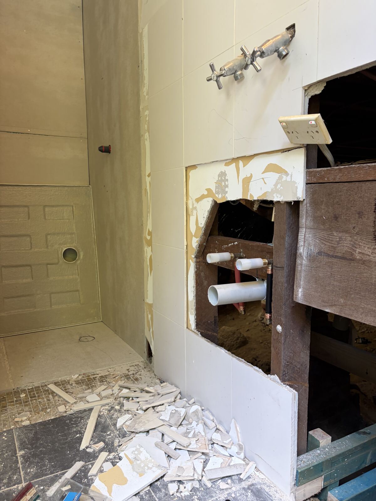Bathroom rough-in behind tiled wall