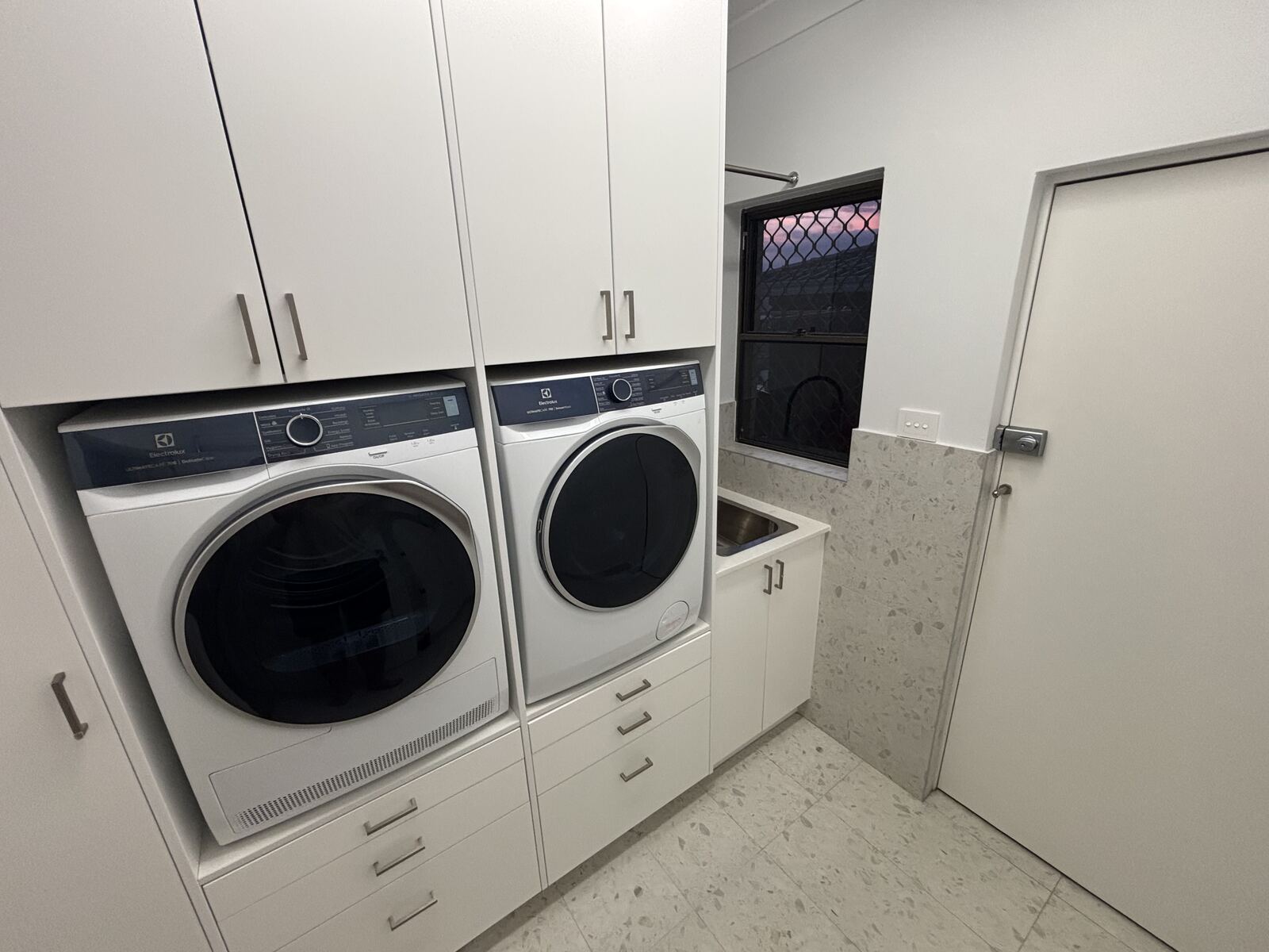Laundry with cabinetry and appliances