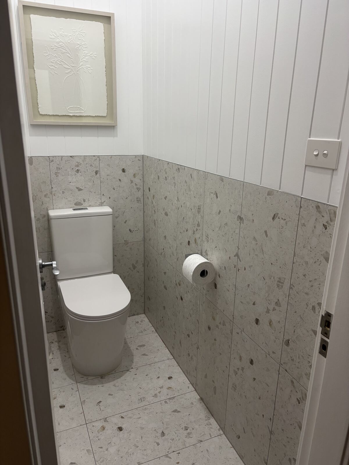 Finished powder room with terrazzo tile